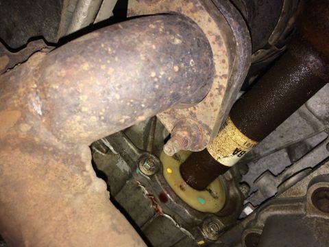 2011 Ford Elite - Driveshaft and exhaust pipe connection detail, likely from a vehicle's undercarriage.
