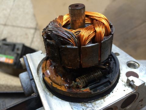 2011 Ford Elite - Close-up of a damaged motor rotor, showing burnt copper windings and a broken stator component.