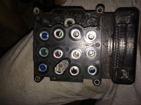 2011 Ford Elite - This is a close-up view of an automotive ABS control module, showing its various connection ports.
