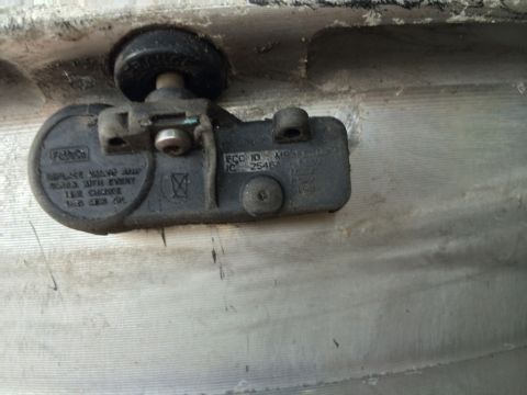 2011 Ford Elite - A Ford branded Tire Pressure Monitoring System (TPMS) sensor is visible, showing its FCC ID and IC number.
