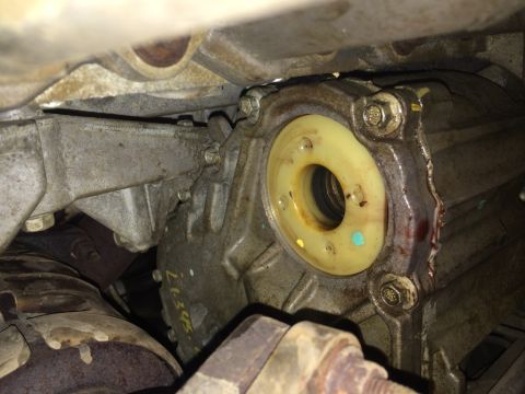 2011 Ford Elite - This photo shows a close-up view of a vehicle's transfer case seal, with visible markings and some fluid residue.