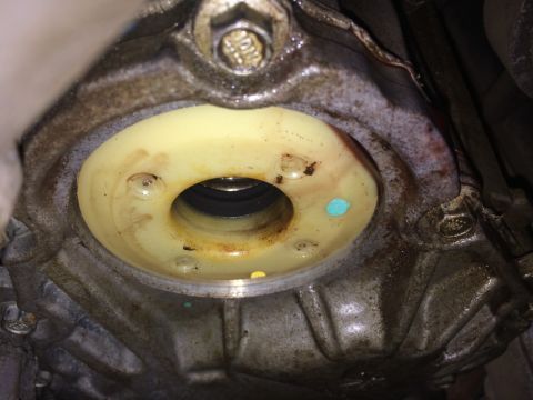 2011 Ford Elite - This image shows a close-up of an automotive part, likely a seal within a housing, with visible bolts and some discoloration.