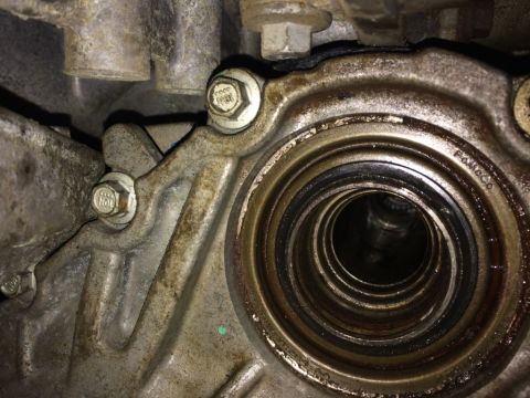 2011 Ford Elite - Automotive transmission part with a seal, showing bolts and some visible text.
