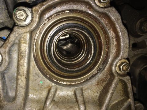 2011 Ford Elite - This image shows a close-up view of a mechanical part, likely a seal housing, with visible grease and wear.