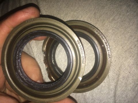 2011 Ford Elite - Close-up of two metal seals, one showing damage to its rubber gasket.