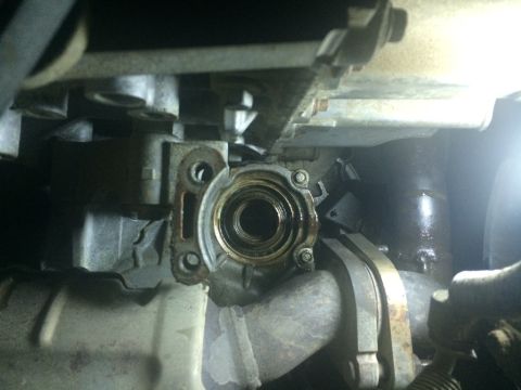 2011 Ford Elite - Underside view of a vehicle's transmission seal housing, showing internal wear and surrounding components.