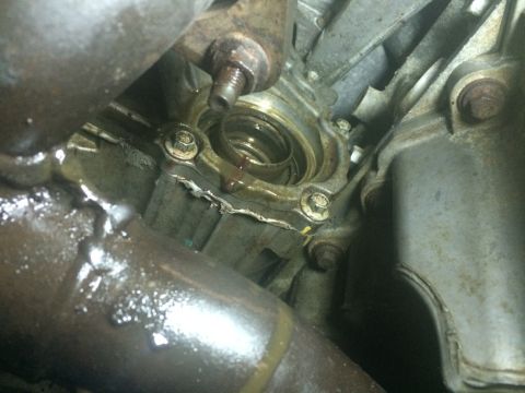 2011 Ford Elite - Engine part showing signs of an oil leak around a seal or gasket.