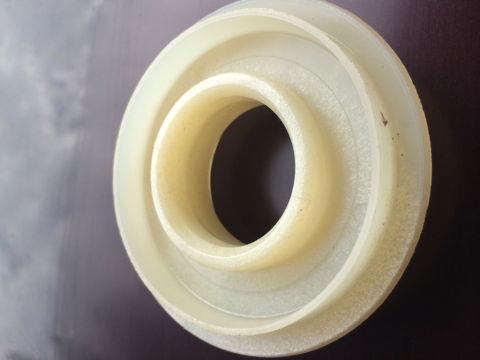 2011 Ford Elite - Plastic bearing or seal shown in close-up, with concentric rings visible.
