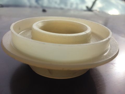 2011 Ford Elite - A beige plastic part with a stepped, circular design is shown in a close-up view.
