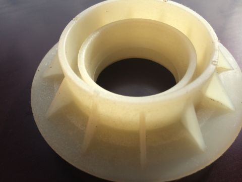 2011 Ford Elite - This beige plastic part has a complex shape with internal and external rings and supports.