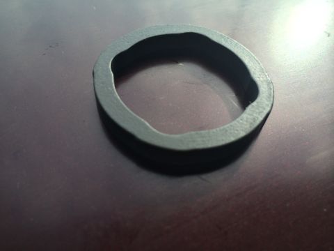 2011 Ford Elite - A rubber seal or gasket is shown on a dark surface.