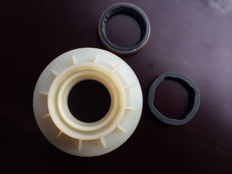 2011 Ford Elite - PTU seals and bearing retainer shown on a dark surface. The registry claims this is for a 2011 Ford Elite, but this is unconfirmed.