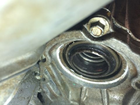 2011 Ford Elite - A close-up view of a worn seal and housing, likely from a vehicle's drivetrain.