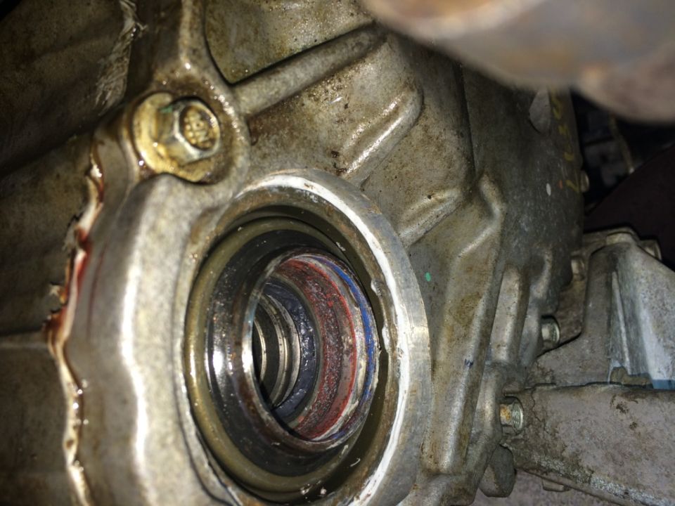 Close-up of a transmission seal with red and blue colored rings