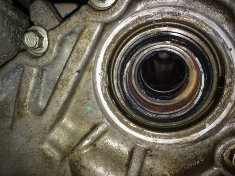 2011 Ford Elite - This image shows a close-up view of a worn seal and bearing assembly within a metal housing.