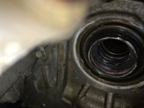2011 Ford Elite - A close-up view of a worn seal within a metal housing, with a bolt on the side.