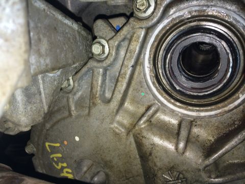 2011 Ford Elite - Close-up view of a transfer case seal, marked with yellow 'L134' and colored dots.
