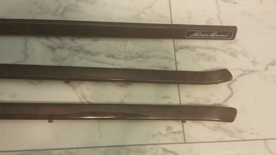 Eddie Bauer trim pieces on a marbled surface