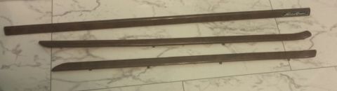 1995 Ford Bronco - Three dark brown car trim pieces, one with an "Eddie Bauer" logo, are laid out on a tiled surface.