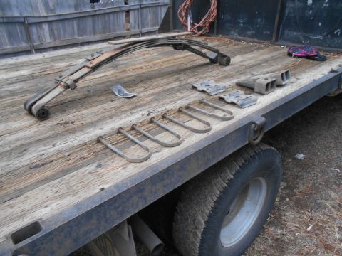 1995 GMC Safari - Leaf springs and U-bolts are visible on the deck of a flatbed truck.