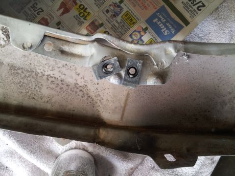 1976 Ford Ranchero - Metal car part with two square nuts, possibly from a Ford Ranchero.