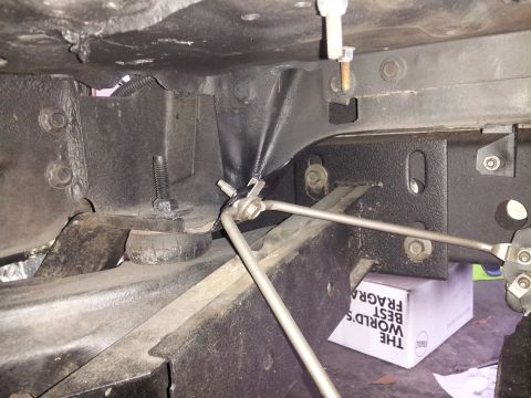 1976 Ford Ranchero - Underside view of vehicle chassis components, including frame, bolts, and brake lines.