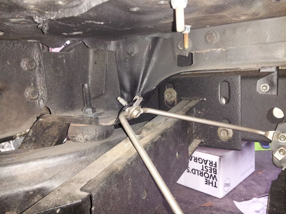 close-up of vehicle frame with some suspension parts and a box underneath