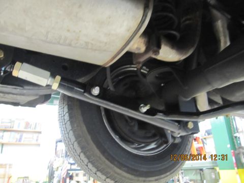 1967 Ford Galaxie - Underside view of a car's rear suspension with an adjustable link installed.