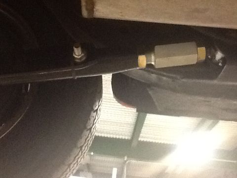 1967 Ford Galaxie - A close-up view of a vehicle's suspension system, focusing on a specific component.