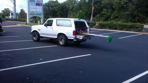 1994 Ford Bronco - Not a very heavy load but one of the most unnerving. This is a 16 foot corrugated panel with a stack of 2X4s underneith. Usually I strap a…