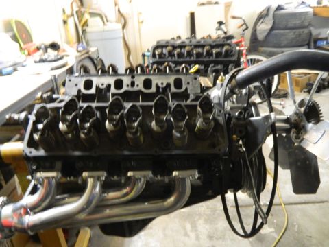 1979 Ford Bronco - Engine block with exhaust headers and fan assembly. Engine is partially disassembled.
