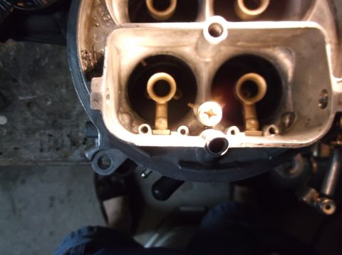 1979 Ford Ranchero - A close-up view of the inside of a carburetor, showing two venturi openings with brass components and a screw. The carburetor appears to be…