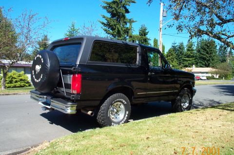 1995 Ford Bronco - Black 1995 Ford Bronco with a spare tire mounted on the rear door.
