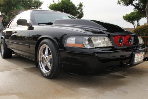 2003 Ford Crown Victoria - Photograph of a black Mercury Marauder sedan, not a technical document.