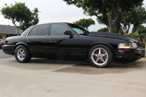 2003 Ford Crown Victoria - Side profile photograph of a black Mercury Marauder sedan, not a technical document.