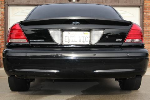 2003 Ford Crown Victoria - Rear-end photo of a black Ford Crown Victoria SVT showing the trunk and EVIL VIC license plate.