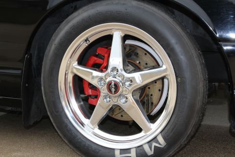 2003 Ford Crown Victoria - Detailed photo of a polished five-spoke drag wheel, red caliper, and M/H Racemaster tire.