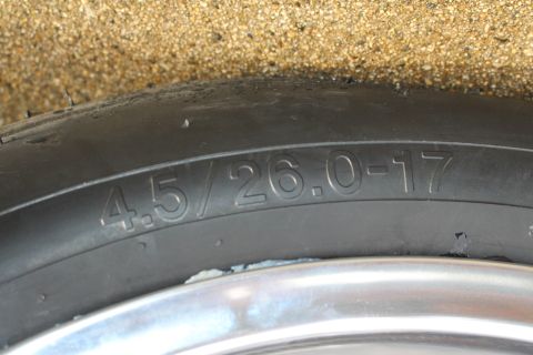 2003 Ford Crown Victoria - Photograph of a drag tire sidewall with molded size marking 4.5/26.0-17, not a technical document.