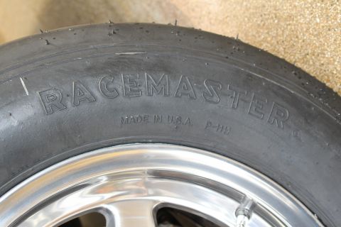 2003 Ford Crown Victoria - Photograph of a Racemaster drag tire sidewall with molded Made in USA lettering, not a technical document.