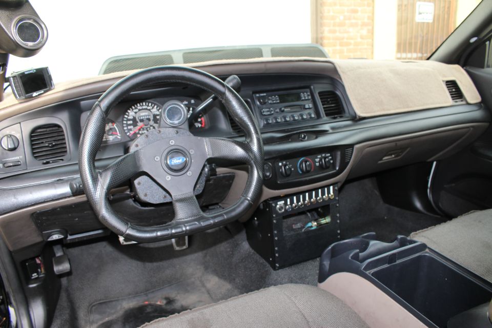 Interior dashboard view of a modified sedan with custom switch panel