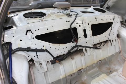 2003 Ford Crown Victoria - Photo of a stripped sedan body showing the bare rear bulkhead and package tray area.