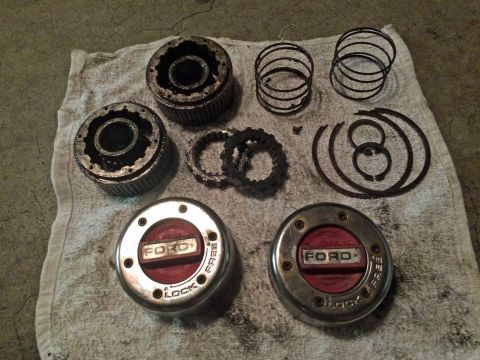 1990 Ford Bronco - A collection of manual locking hub parts, including two complete hubs with "FORD LOCK FREE" text, and various internal components like spri…