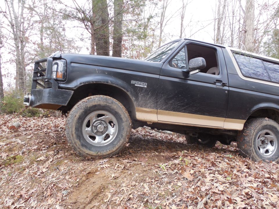 I'm starting at the top of this little hill & backing down to snatch the tree out.  But it's still fairly wet under the leaves, so traction is scant & the truck is sinking in.