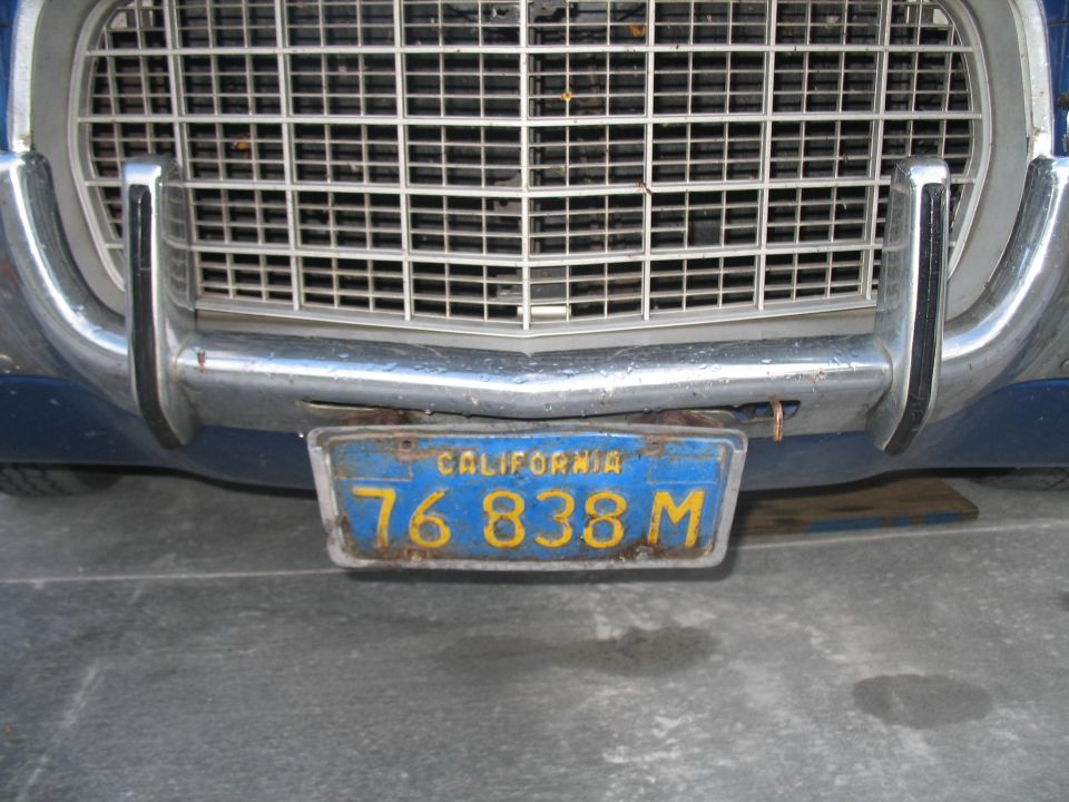 Close up of a blue vehicle's front bumper and California license plate reading "76 838 M".