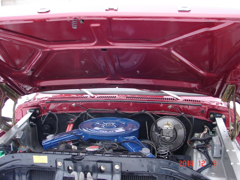 1979 Ford F-150 engine bay with hood open, showing blue air filter.
