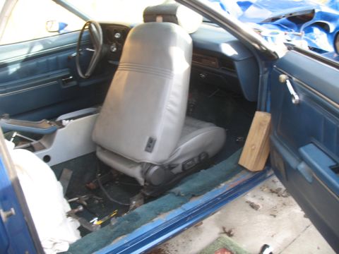 1972 Ford Ranchero - The interior of a 1972 Ford Ranchero shows blue door panels and grey bucket seats.