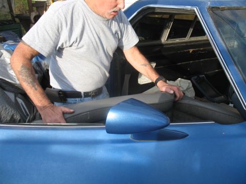 1972 Ford Ranchero - A man works on the interior of a blue 1972 Ford Ranchero.