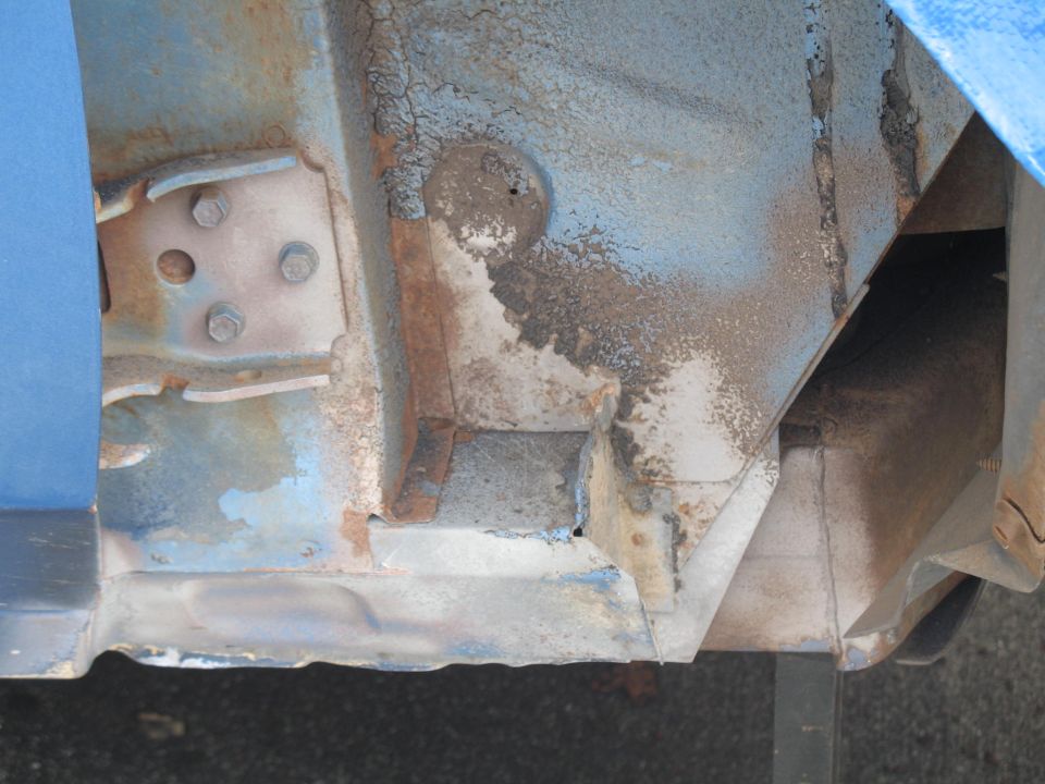 rusted metal frame and body panel, blue paint