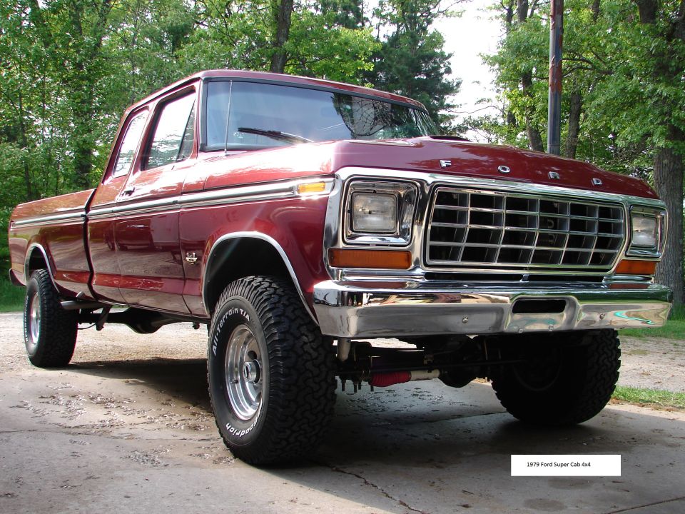 1979 Ford F-150 Super Cab 4x4 pickup truck, dark red, chrome grille and bumpers, parked outdoors.