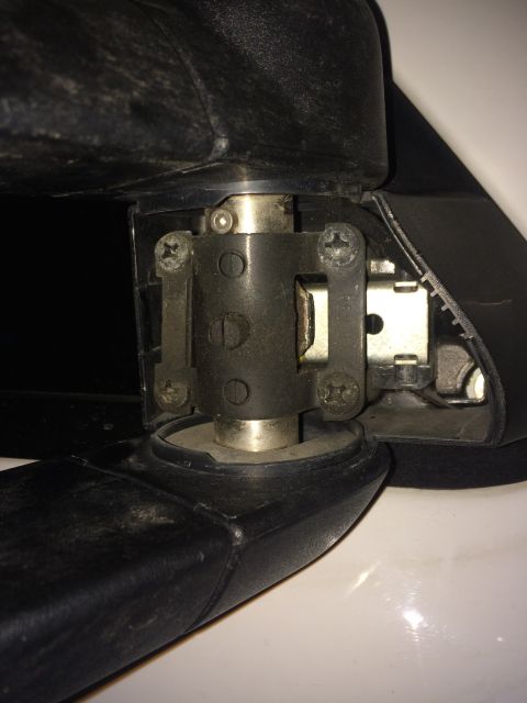 2006 Chevrolet Silverado 2500 - A close-up view shows the internal mechanism of a vehicle's seat adjustment lever, with visible screws and metal components.